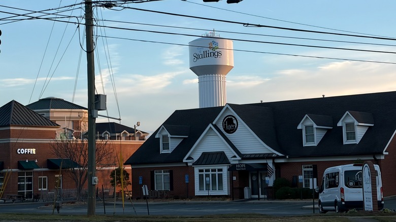 buildings with water tower along small street in Stallings
