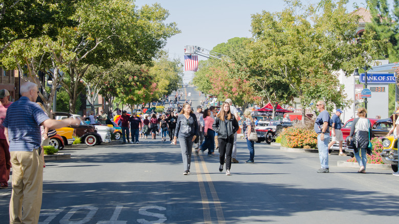 People walking down the street of Rio Vista during a car show