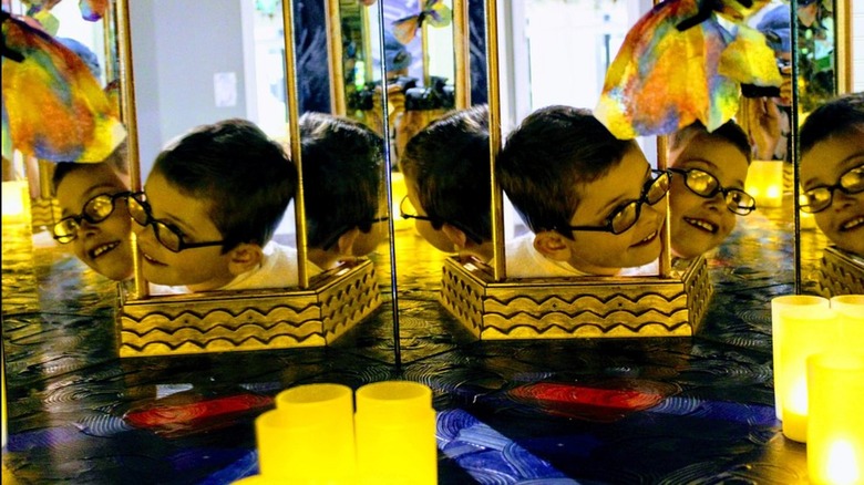 A child looking through the Infinity Box at the Santa Cruz Children's Museum of Discovery at Capitola Mall