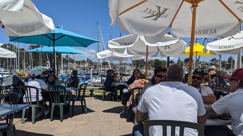 Umbrella's shade a patio with tables overlooking the Santa Cruz Harbor at Aldo's Harborside Restaurant.