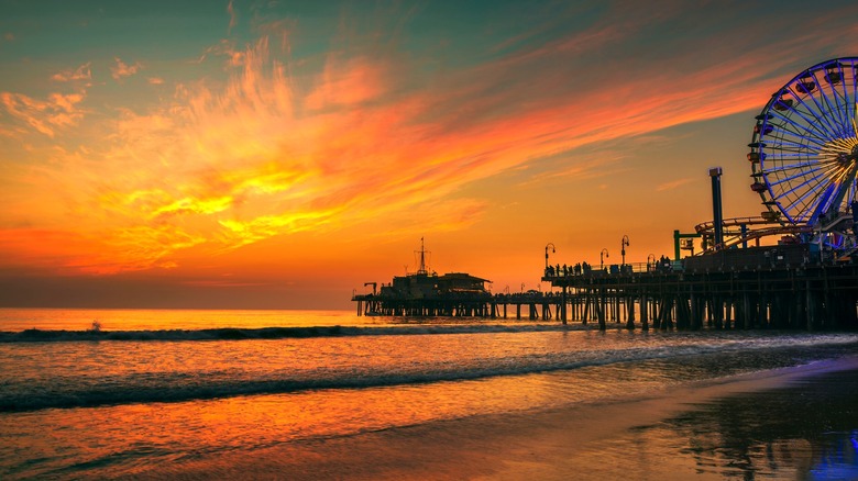 A striking, colorful beach sunset at Santa Monica Pier in Santa Monica, Los Angeles, California