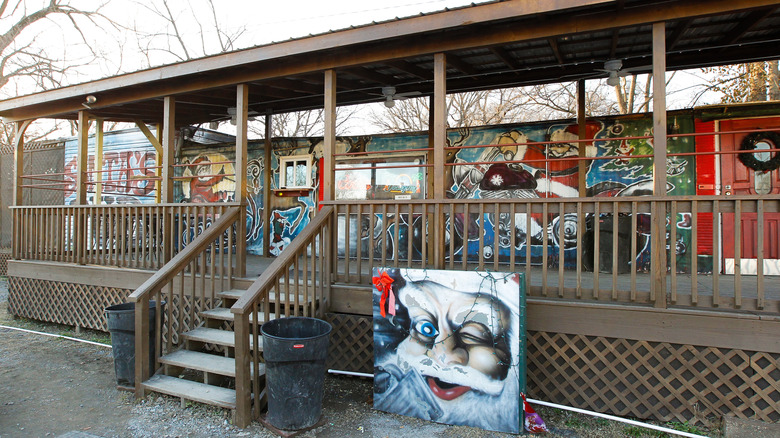 A view of the exterior of Santa's Pub, a double-wide trailer covered in murals of Santa