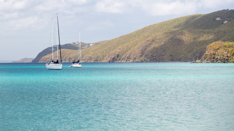 Two sailboats anchored off shore from Brewers Bay Beach in St. Thomas