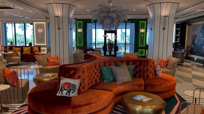 Curved couches, tent-inspired pillars, and a feathered lighting feature in the Cirque St. Armands Beachside lobby