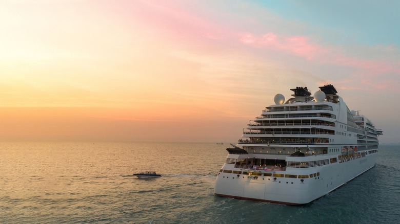 A ship cruising at sunset