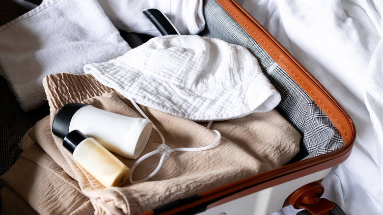suitcase holding skincare, toiletries, and other essentials