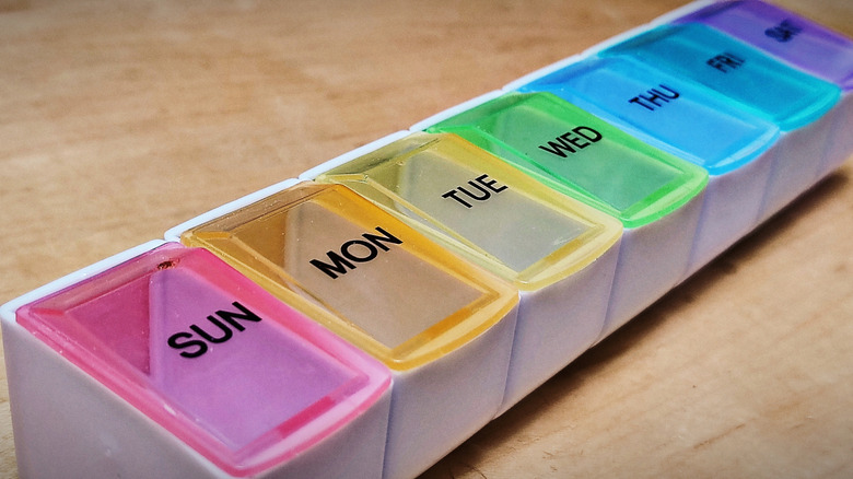 a pill organizer laying flat with seven compartments