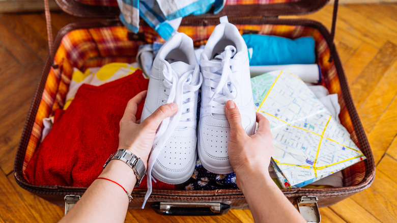 large sneakers in small suitcase