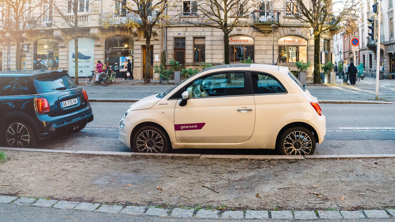 Car parked on the side of a street with a Getaround logo