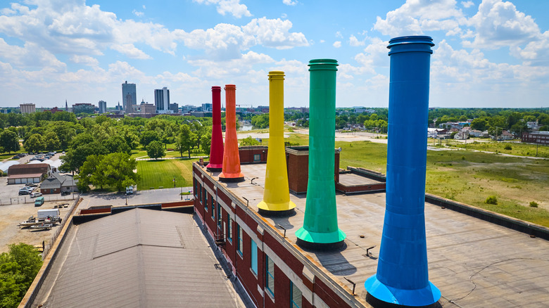 Rainbow painted smokestacks at Science Central with Fort Worth and green trees in the distance.
