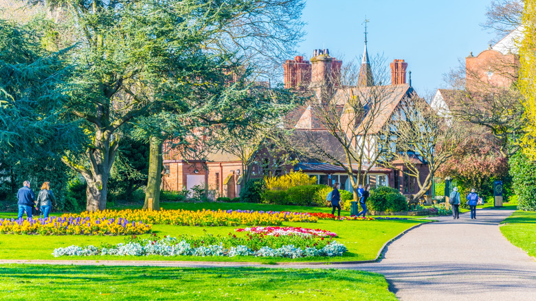 People walking through a park in an idyllic English environment