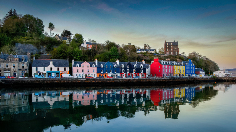 Colorful buildings of a harbor town reflected on the water's surface