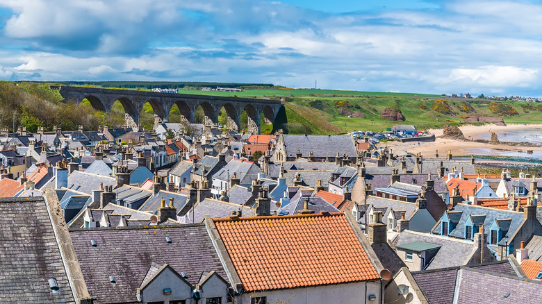 Rooftops of cottages in Cullen, Scotland overlooked by an old viaduct