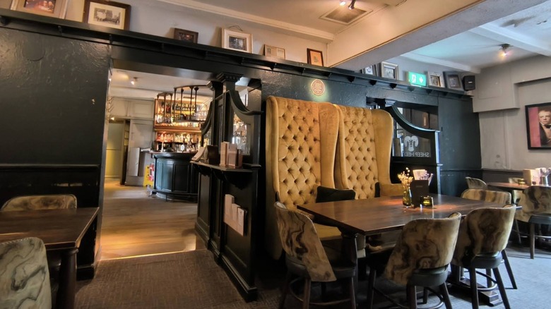 A dining area with high-back chairs at Sheep Heid Inn.