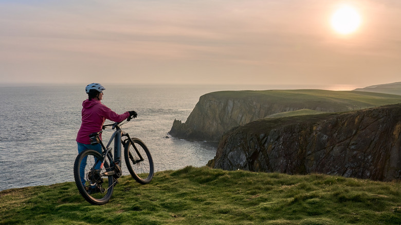 A cyclist watching the sunset at the Mull of Galloway