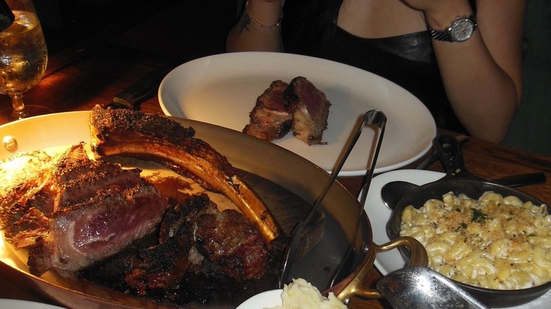 Bone-in steak with side of mac and cheese at The Metropolitan Grill