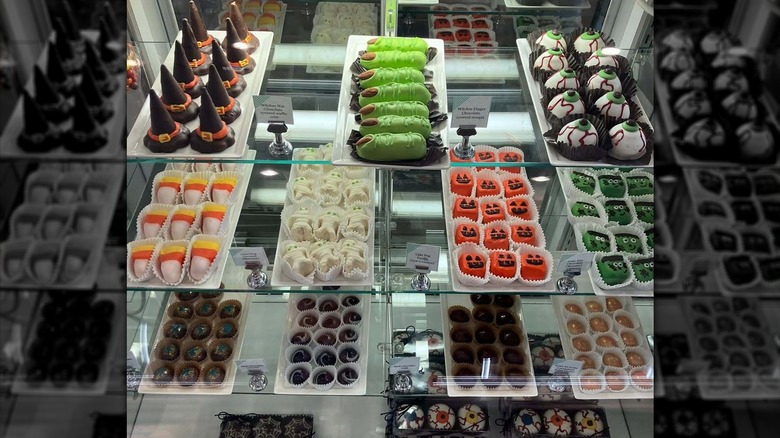 An array of Halloween-themed candies and fudge on shelves