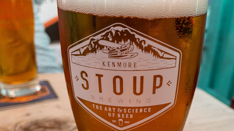 A closeup of a tall pint glass from Stoup Brewing, a brewery in Ballard