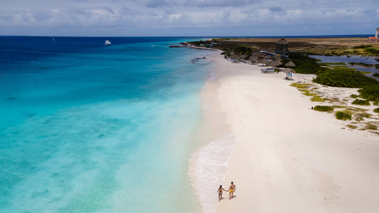 An expanse of white sand and pale blue sea on a remote Curacao island