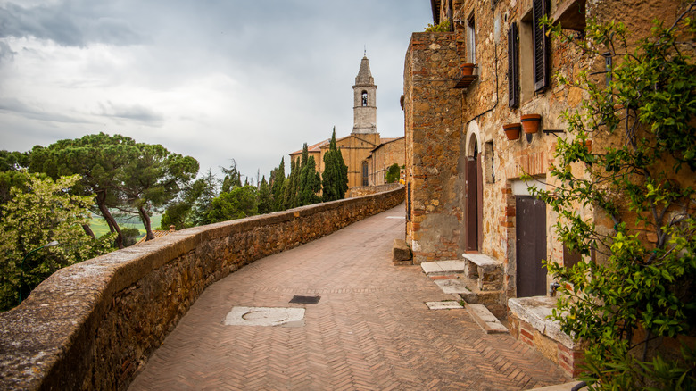 Old medieval walls and narrow streets with a steeple in Montalcino