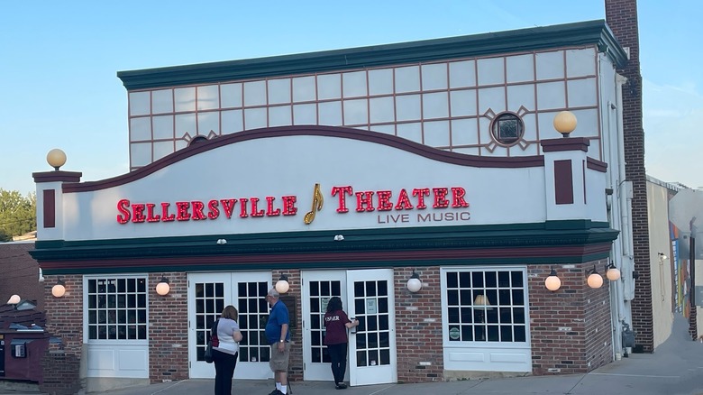 Patrons in front of the Sellersville Theater in Sellersville, Pennsylvania on a clear blue-sky day
