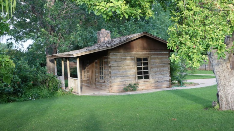 Old wooden house in middle of green yard