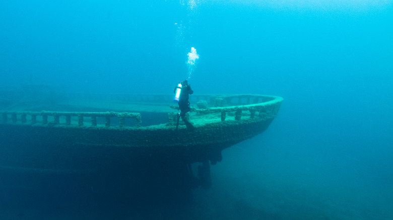 Scuba diver viewing a shipwreck under the Thunder Bay National Marine Sanctuary