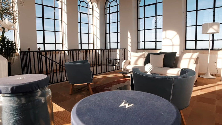 Interior of a living room with large, sunny windows at Villa Torre Bianca in Italy