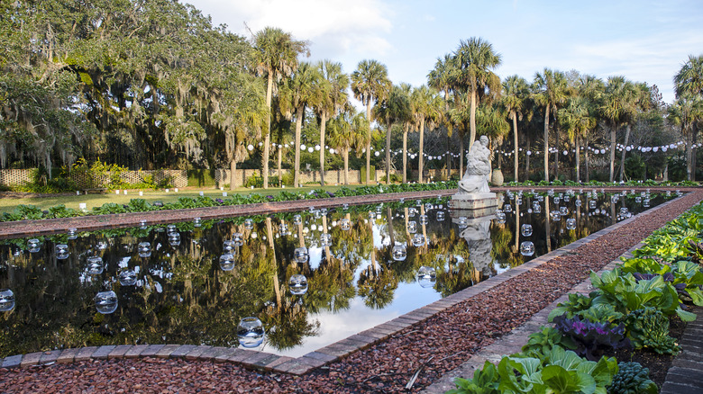 Pond with central sculpture surrounded by trees at Brookgreen Gardens, SC