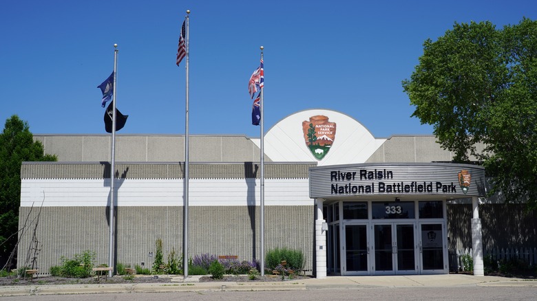 Flags flap in the wind outside the Visitor Center in River Raisin National Battlefield Park
