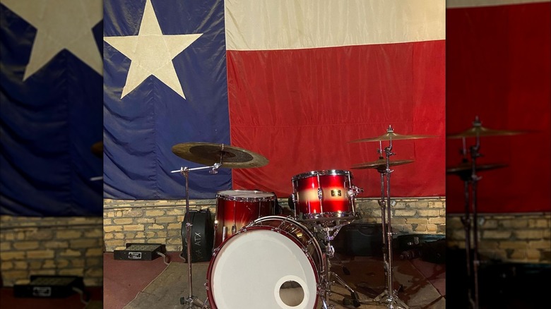 Drum set with Texas flag in background