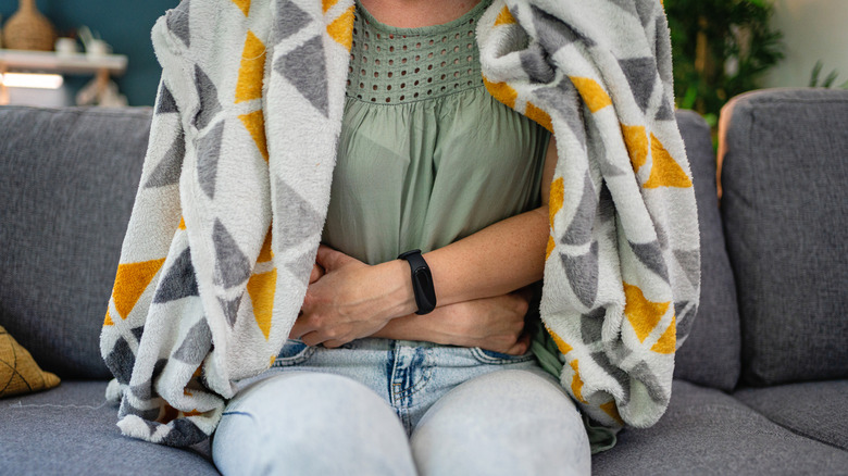 Person dealing with an upset stomach