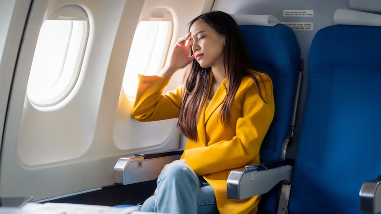 Woman feeling sick on a plane