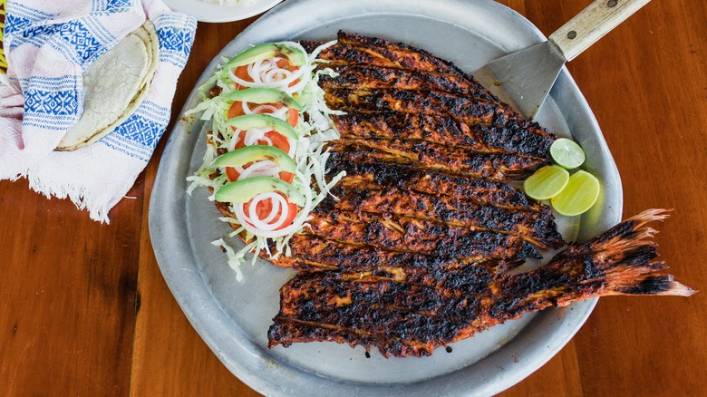 Mexican fried fish with tortillas, rice, and salad