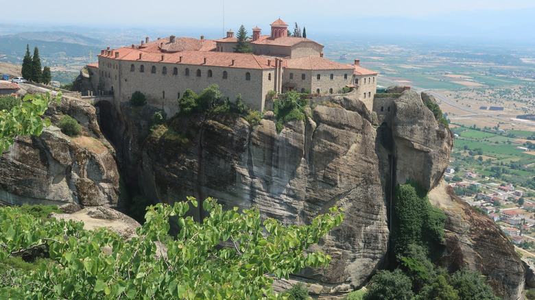 A clifftop monastery at Meteora overlooking the town of Kalabaka, Greece