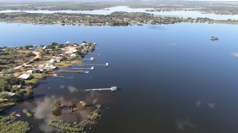 Aerial view of Oak Creek Reservoir in Texas with small buildings on the shoreline
