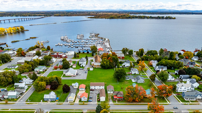 Aerial of Rouses Point with view of homes, marina, and lake