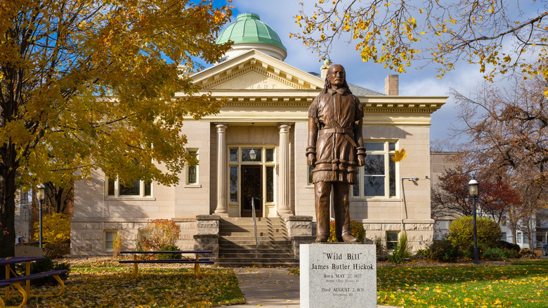 Carnegie Library in Mendota with a Wild Bill Hickok statue in front
