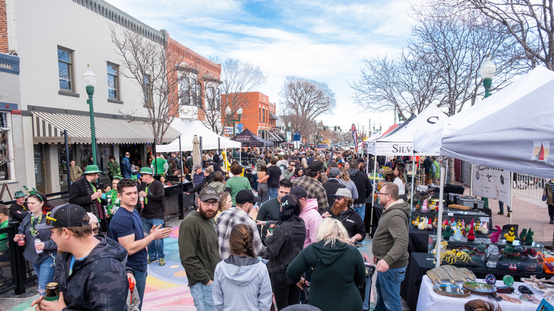 A crowd of people is pictured at a farmer's market in Arvada