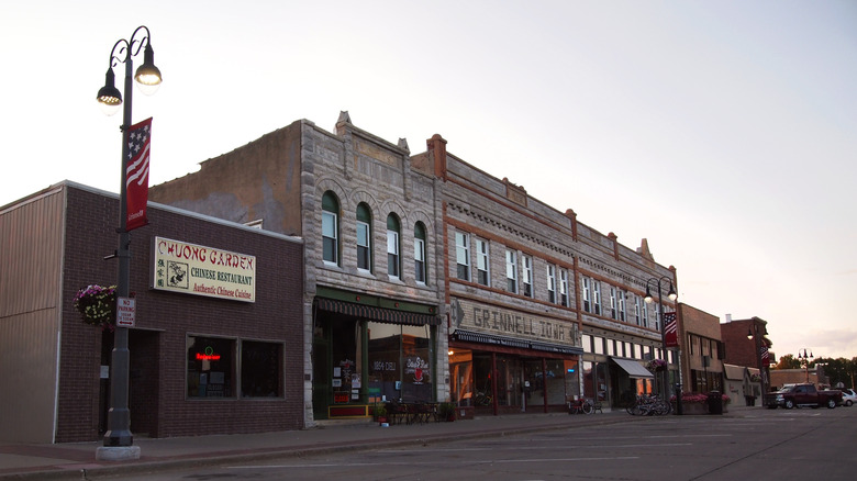 GRINNELL, IA - JULY 27, 2018: The 900 block of Broad St. in the downtown historic district of Grinnell, Iowa, just after sunset on a summer evening.