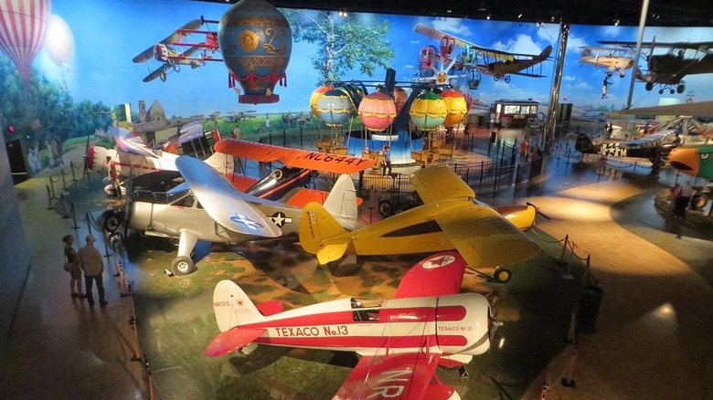 An aerial view of planes and an indoor hot air balloon ride inside of the Air Zoo Aerospace & Science Experience