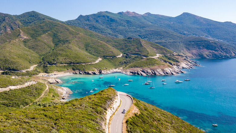 A road and sandy bay in Corsica