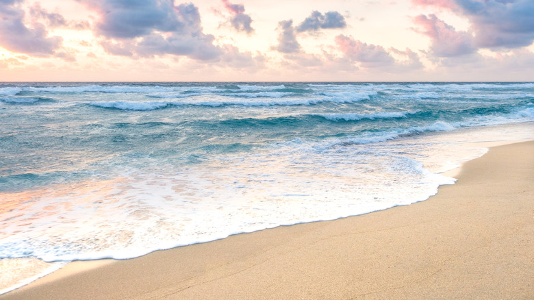 Colorful clouds highlight the ocean and beach