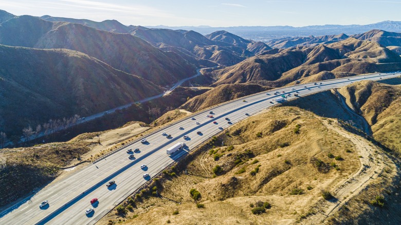 Cars drive on a motorway in Southern California