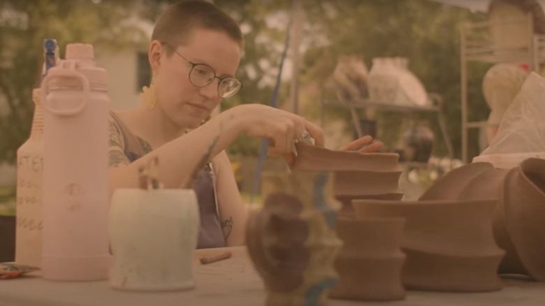 Person working on pottery