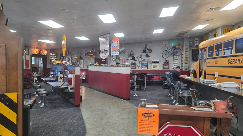 Interior of Derailed Diner with school bus, gas station signs