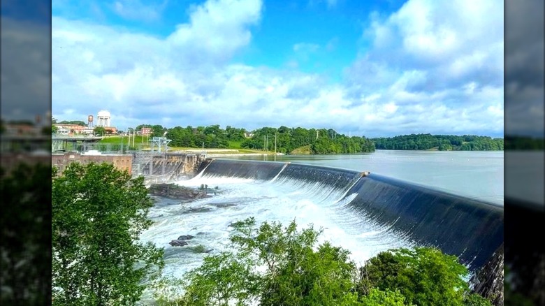The Thurlow Dam with water spilling over on a beautiful partly cloudy day