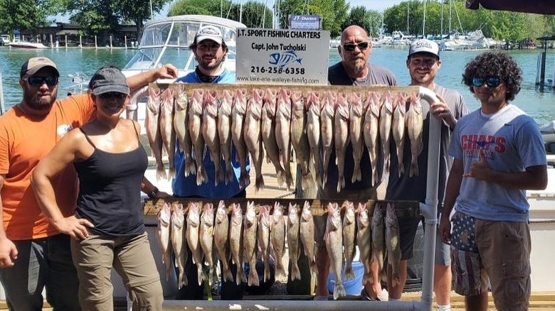 people standing beside fish