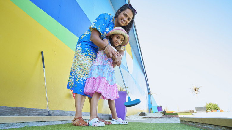 Mother and daughter playing golf