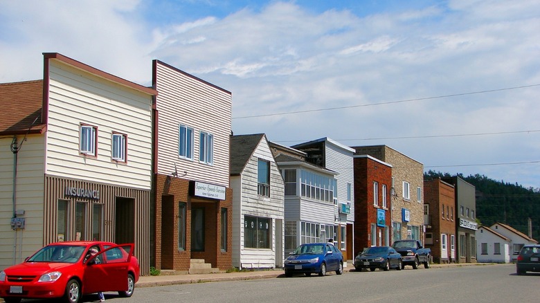 A row of old brick and timber shopfronts along a main street in Schreiber, Canada.